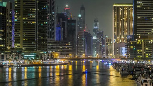 Promenade and canal in Dubai Marina timelapse at night, UAE. 