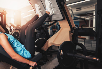 Woman working exercise on training apparatus in club