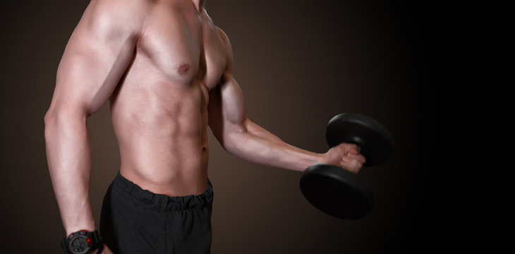 Strong man working at gym fitness club