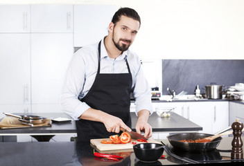 Chef preparing dishes in a frying pan