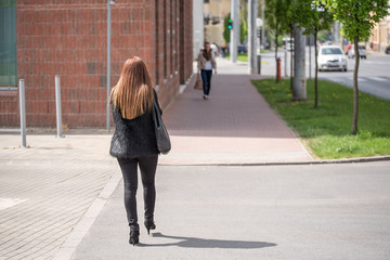 Long hair woman walking in the street