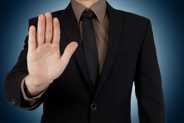 Businessman showing stop or stay gesture 