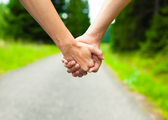 Image of female and male hands together.

