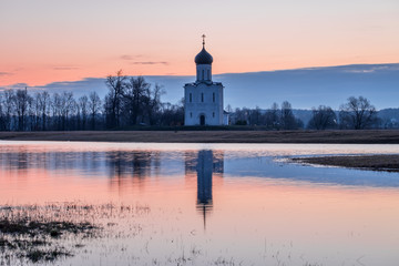 Spring landscape in the early morning with the tide in the vicinity of the temple of the Intercession on the Nerl in Vladimir region in Russia