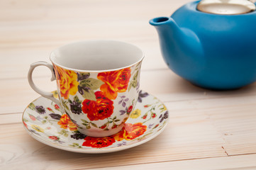 Tea cups with teapot on old wooden table