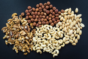 Almonds, cashew, walnuts and hazelnuts on black background