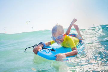 Little boy surfboarding