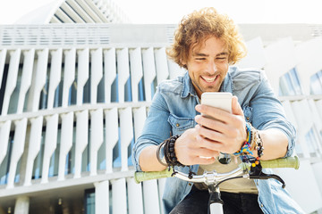 Portrait of Handsome young man smiling when he is using his mobi