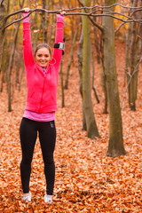 Young sporty girl doing exercises in forest.