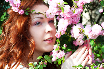 Naklejka premium Woman enjoying wild rose smell