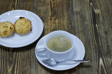 A Cup of hot coffee with biscuits