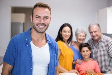 Handsome young man standing in kitchen
