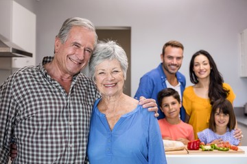 Elderly man and woman standing in kitchen