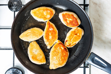 Fried patties on pan.