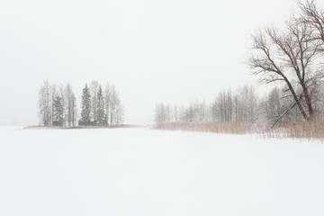 Blizzard winter landscape at frozen lake