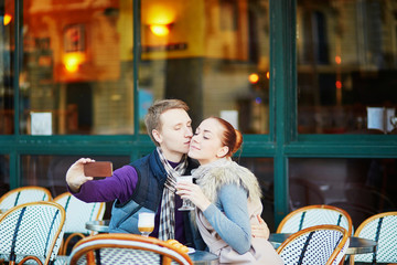 Fototapeta na wymiar Young romantic couple in cafe in Paris