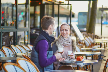 Young romantic couple in cafe in Paris