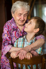 Grandmother hugging her little grandson.