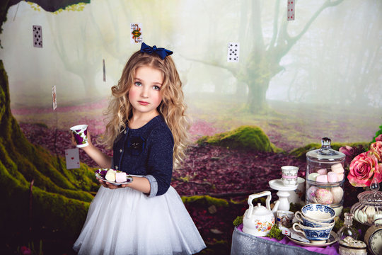 Beautiful blonde girl as Alice in Wonderland 