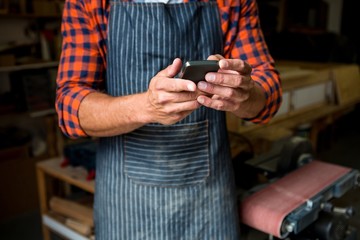 Carpenter is looking at his phone