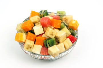 assorted fruit chopped in cubes on a plate on white background