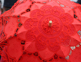red umbrella hand-decorated with lace doilies