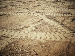 Wheel tracks on the soil.