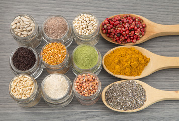 Variety of spices and grains on wooden background