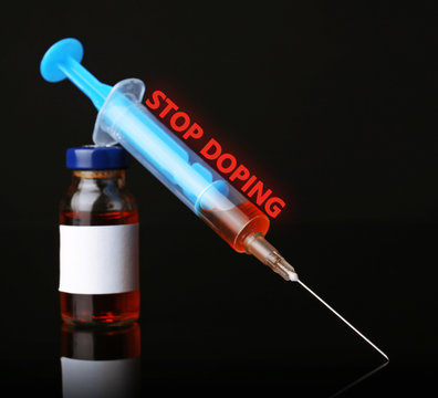 Stop doping concept. Ampule and syringe isolated on black