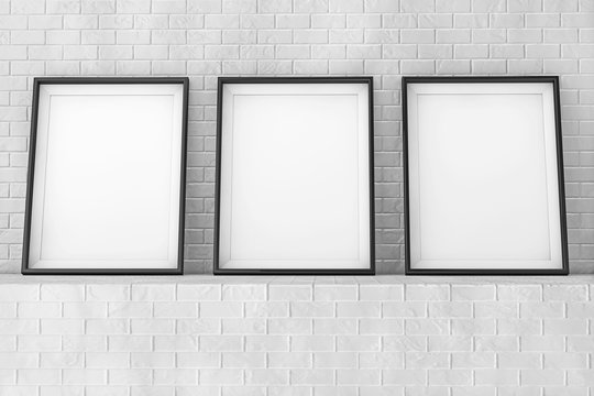 Blank Picture Frames on the Brick Wall. 3d Rendering