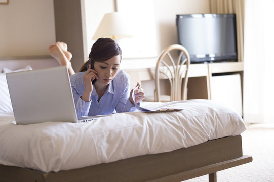 Women have to work lying face down on a bed in a hotel room