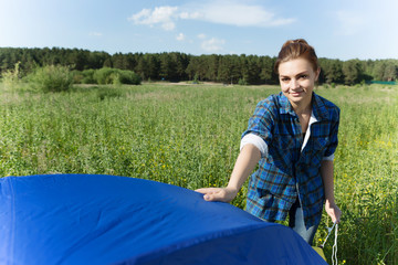 Woman fixing tent