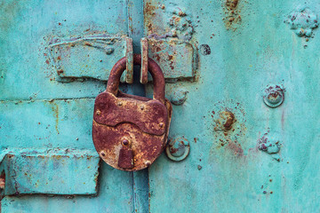 Old padlock on a blue door