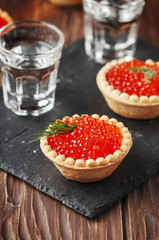 Traditional russian red caviare on the wooden table