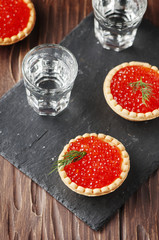 Traditional russian red caviare on the wooden table