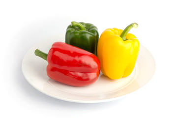 Sweet peppers in ceramic plate on white back ground