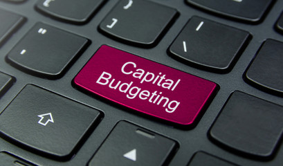 Business Concept: Close-up the Capital Budgeting button on the keyboard and have Magenta color button isolate black keyboard