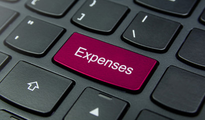 Business Concept: Close-up the Expenses button on the keyboard and have Magenta color button...