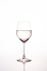 Water in wine glass on white background