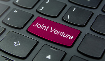 Business Concept: Close-up the Joint Venture button on the keyboard and have Magenta color button isolate black keyboard
