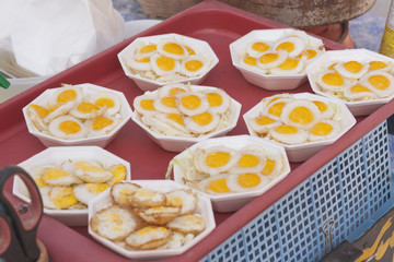 Fried Quail's egg on styrofoam plate , Thai style