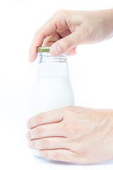 Woman hand open traditional glass milk bottle