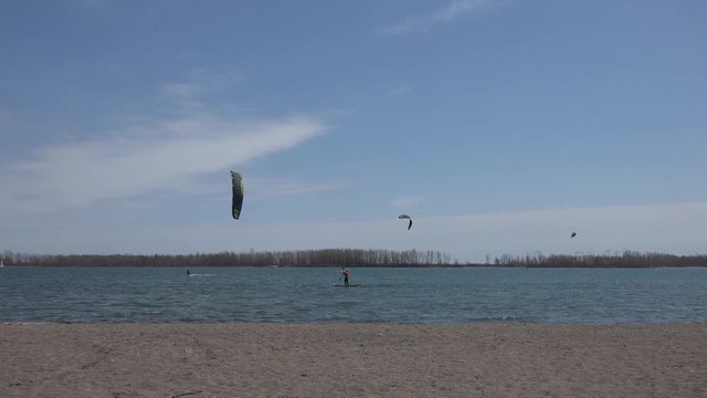 Kitesurfers and Paddleboard