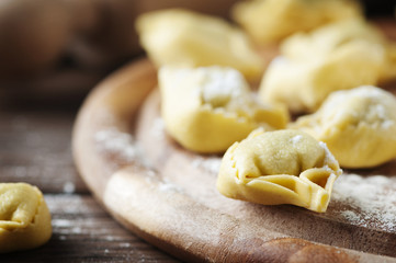 Italian traditional  tortellini on the wooden table