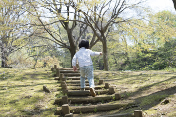 Young boy is up the stairs of the park