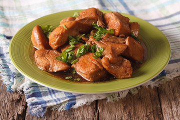 Chicken braised in a sauce Adobo close-up on a plate. horizontal

