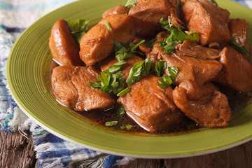 Delicious Filipino Food: Adobo chicken with herbs close-up. horizontal
