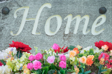 "HOME" label wooden with bunch of flower.