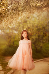 Fototapeta na wymiar cute little girl in a spring garden