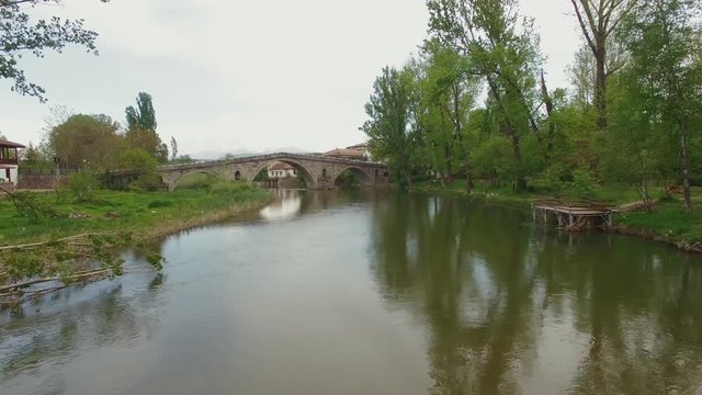 Aerial video over Struma river at spring / Old stone brodge from 1450 year
